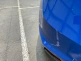 a blue car that is parked in a parking lot