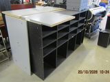 a workbench in the middle of a room with a lot of shelves