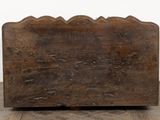 an old wooden chest sitting on top of a hard wood floor