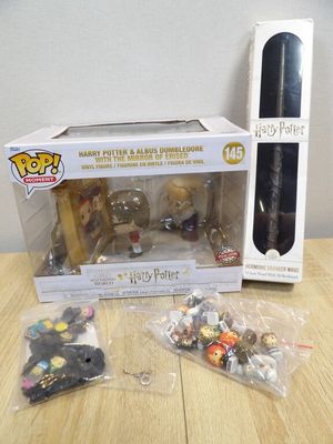 harry potter figurines and accessories on a table in front of a box