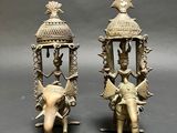 pair of antique brass figurines of a man and a woman riding on an elephant