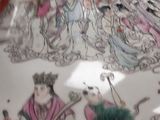 a large vase with a painting on it in a room