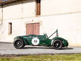 a green race car parked in front of a building