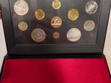 an open box with coins in it sitting on a red surface