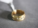 a close up of a gold ring with diamonds on it