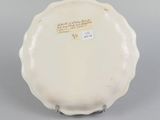 a close up of a plate with writing on it on a gray surface