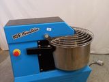 an image of a blue machine with a bowl on it