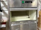 a stainless steel oven sitting on a pallet in a warehouse
