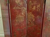 a red room divider with a floral design on it