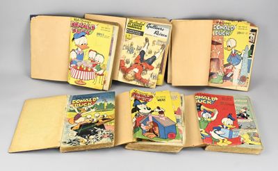 six books of walt comics are lined up on a table