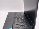 a laptop computer sitting on a table with a keyboard