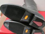 they are two pairs of black boots on a red box