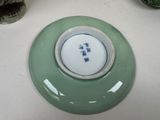 a green plate with a blue and white design on it