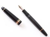 two pens sitting next to each other on a white surface