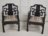 pair of asian style chairs with upholstered arms and back cushions