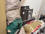 a pile of bags sitting on top of a table in a room