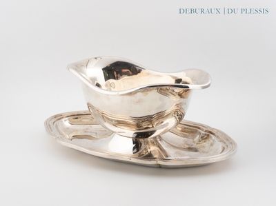 a silver plate with a saucer and a spoon on it