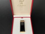 an image of a black and gold cell phone in a red box