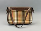 the small vintage checkered bag is made from brown leather and has a brown strap