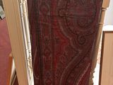a chair that has a red and black paisley pattern on it