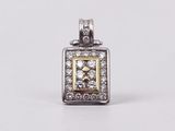a close up of a diamond pendant on a white surface