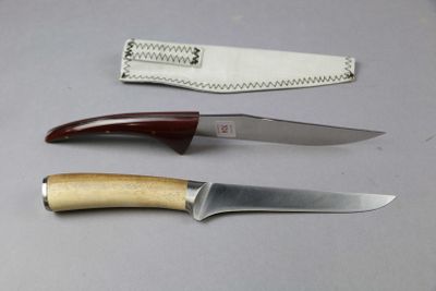 three different types of knives sitting on a table