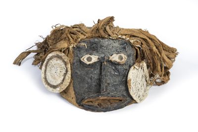 an image of a mask with a face made out of wood