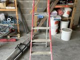a ladder that is leaning against a wall in a garage