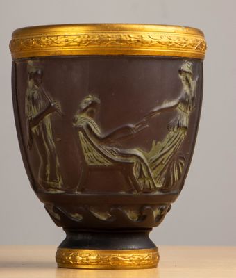 a vase with a painting on it sitting on a table