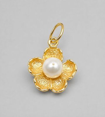 a close up of a pearl flower pendant on a white background
