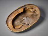 a close up of a sculpture of a dog inside of a shell