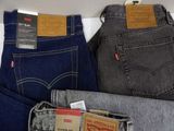 three pairs of levi ' s jeans are on display in a store