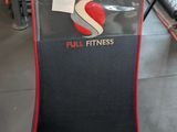 a close up of a chair with a red and black seat pad