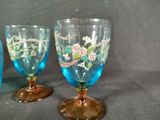 three wine glasses sitting on a table next to each other