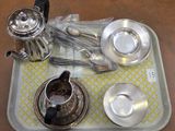 a tray with silverware on it and a cup and saucer