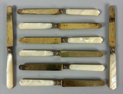 several knives and knives are arranged in a row on a table