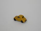 yellow toy car sitting on a white surface in the snow