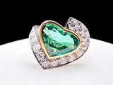an image of a heart shaped ring with a green tourmaline