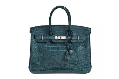 a green crocodile skin handbag with a metal clasp