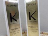 two bottles of kerastasee hair care sitting on top of a wooden table