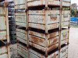 a stack of metal crates sitting in the dirt