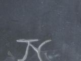 graffiti on a window sill of a building with a bicycle drawn on it