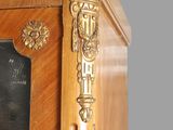 a wooden cabinet with a mirror on top of it