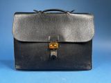 a black leather briefcase with a lock on it