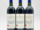 trois bouteilles de vin rouge posées sur une surface blanche