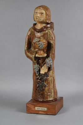 an image of a statue of a woman holding flowers on a wooden base