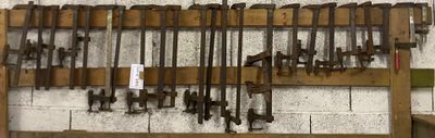 a lot of tools hanging on the wall in the garage