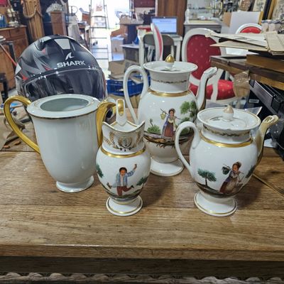 many different types of teapots on a wooden table
