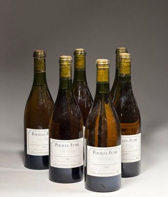six bottles of wine are lined up in a row on a white surface