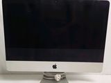 an apple computer monitor sitting on top of a desk next to a keyboard